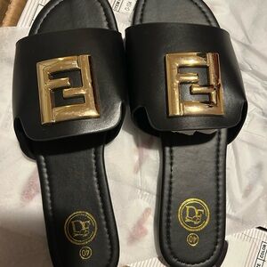 Black Slide Sandals with Gold Accent Logo